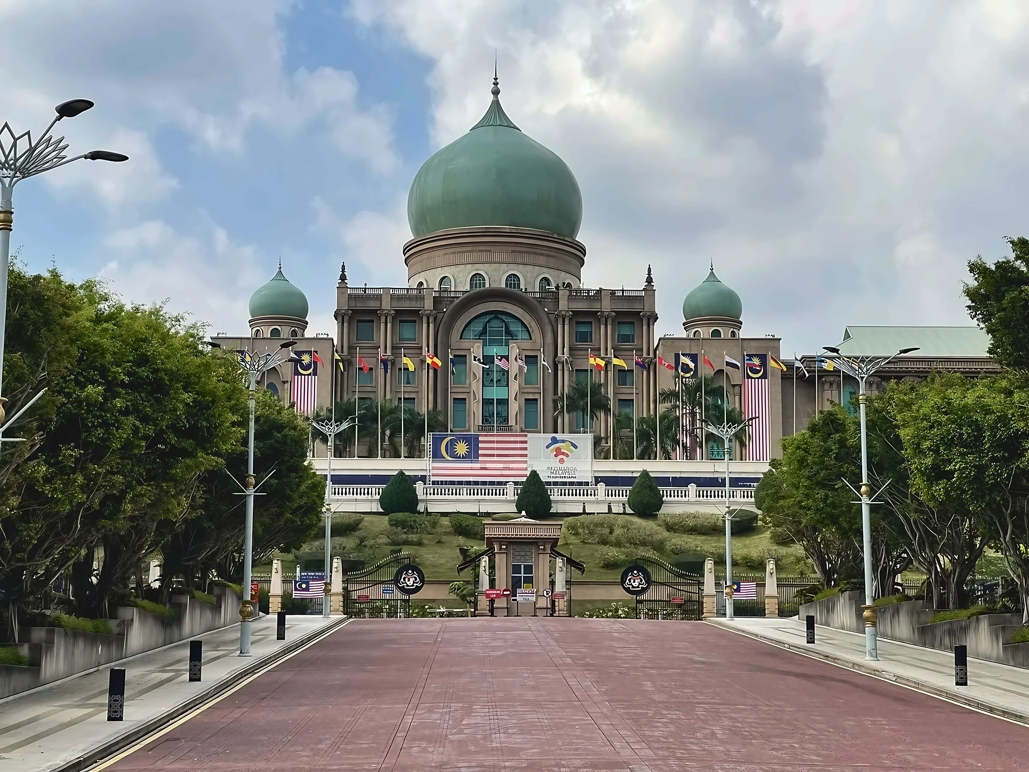 A red-paved road leads to Perdana Putra, with its green domes, Malaysian flags and landscaped grounds.