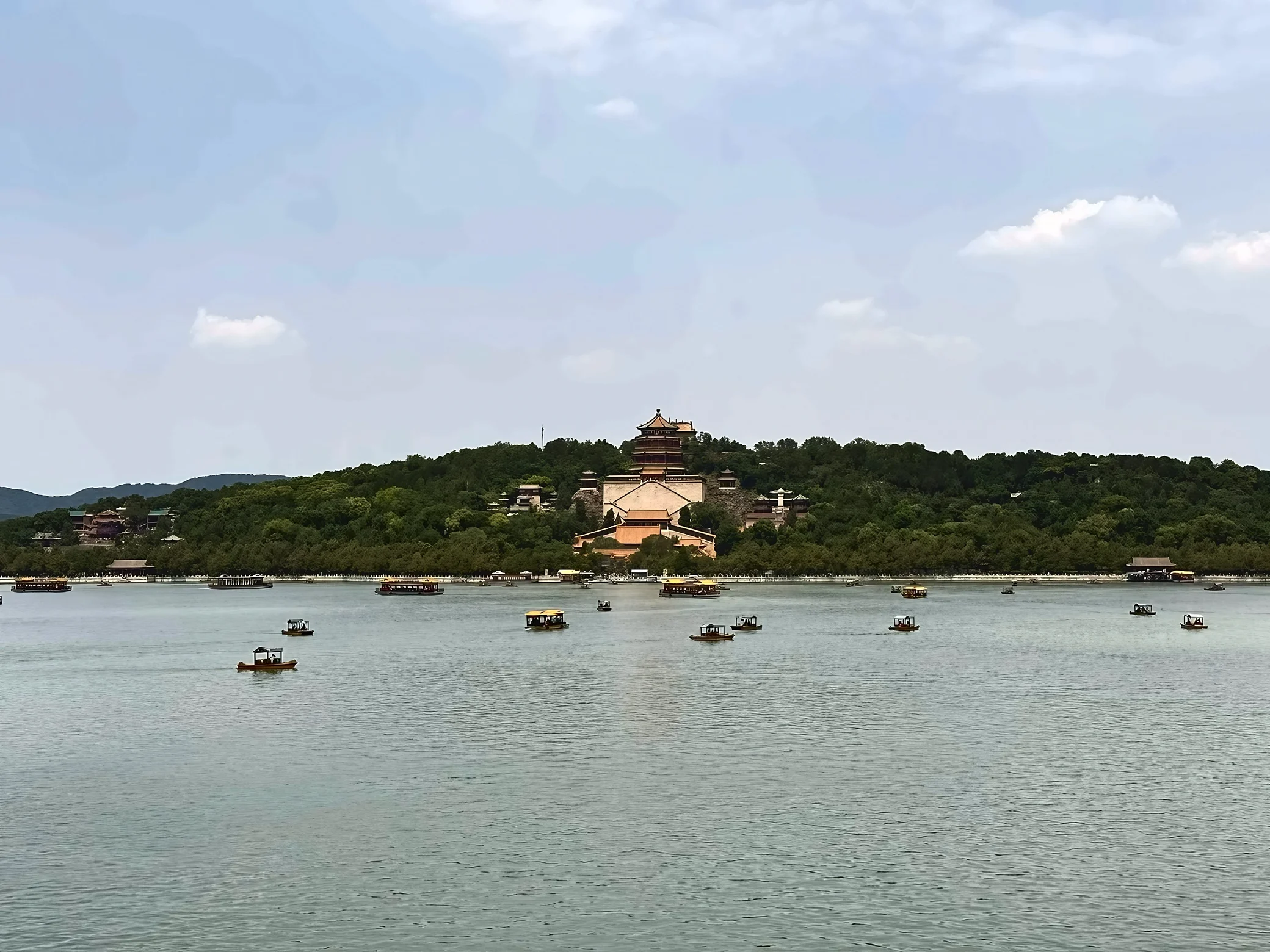 Boats dot Kunming Lake below the wooded Longevity Hill and the Tower of Buddhist Incense at the Summer Palace.